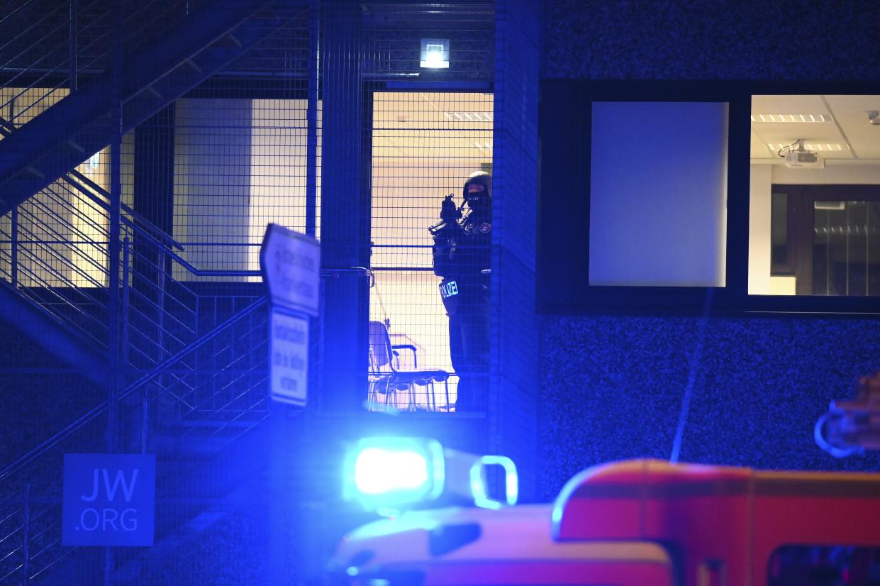 Armed police officers near the scene of a shooting in Hamburg, Germany on Thursday March 9, 2023 after one or more people opened fire in a church. The Hamburg city government says the shooting took place in the Gross Borstel district on Thursday evening. (Jonas Walzberg/dpa via AP)