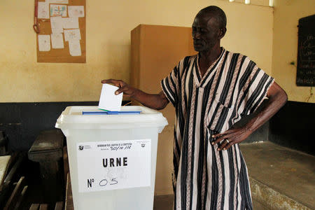 A man casts his vote at a polling station during a referendum on a new constitution, in Abidjan, Ivory Coast October 30, 2016. REUTERS/Luc Gnago