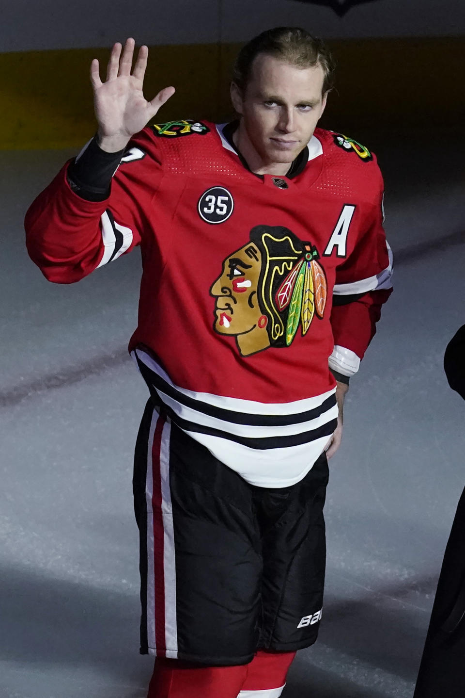 Chicago Blackhawks right wing Patrick Kane waves to fans as he is honored for his 1,000th NHL hockey game, before the team's matchup against the Vancouver Canucks in Chicago, Thursday, Oct. 21, 2021. (AP Photo/Nam Y. Huh)