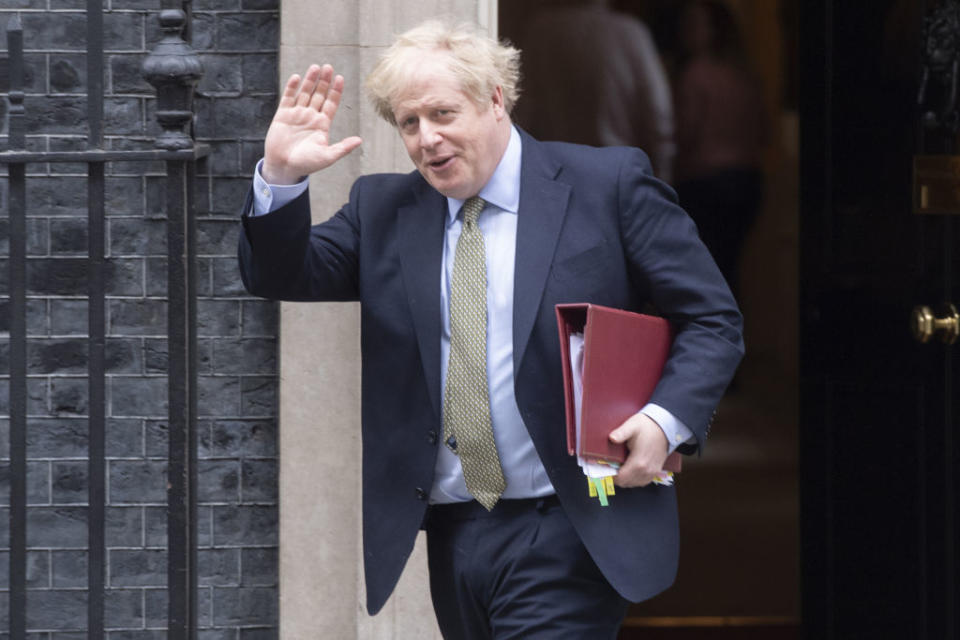 British Prime Minister Boris Johnson waves as he leaves Number 10 at Downing Street, London. 