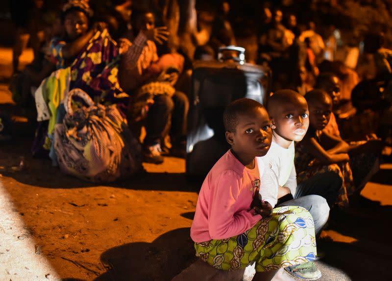 People gather with their belongings following a volcanic activities at Mount Nyiragongo near Goma