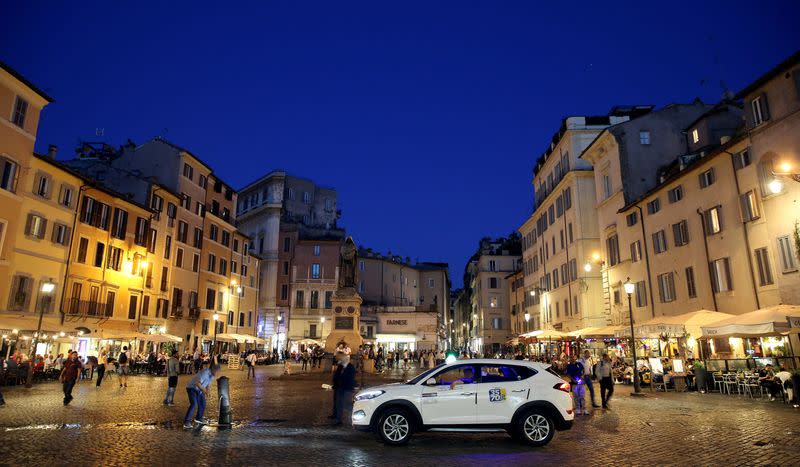 FILE PHOTO: A taxi driver wait for clients at Campo de Fiori square in downtown Rome