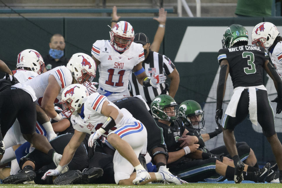 Tulane quarterback Michael Pratt (7), bottom right, scores a touchdown during an NCAA college football game against SMU in New Orleans, Friday, Oct. 16, 2020. (AP Photo/Matthew Hinton)