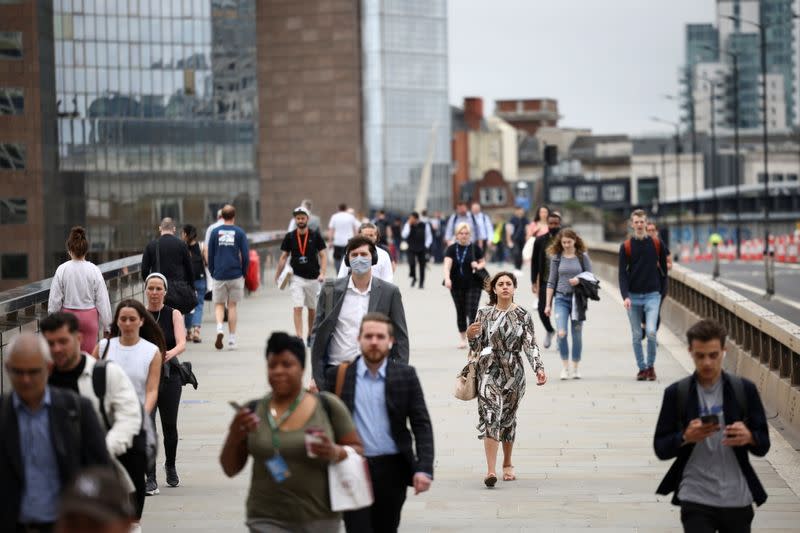 FILE PHOTO: People walk across London Bridge during morning rush hour, in London