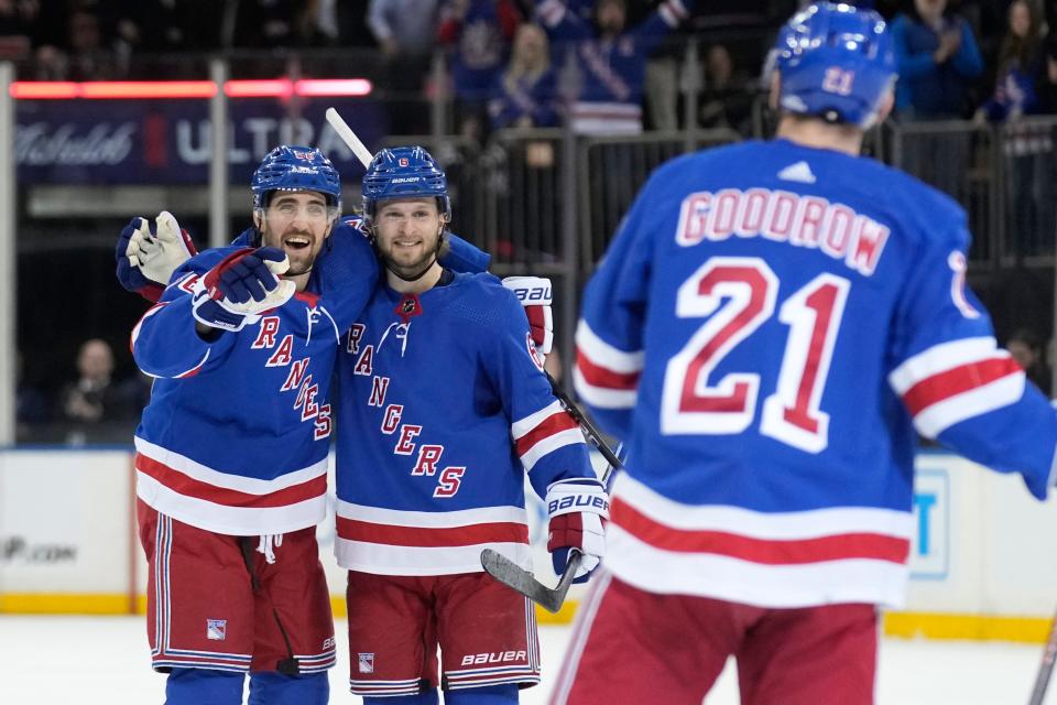 New York Rangers' Erik Gustafsson, left, celebrates his goal with Zac Jones, center, and Barclay Goodrow (21) during the second period of an NHL hockey game against the New Jersey Devils, Monday, March 11, 2024, in New York.