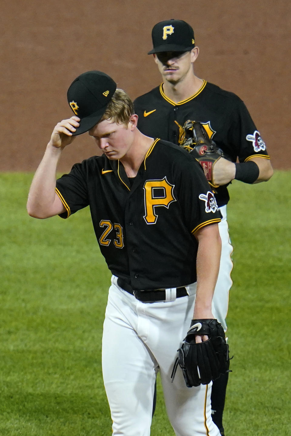 Pittsburgh Pirates starting pitcher Mitch Keller (23) waits to hand the ball to manager Derek Shelton and leave the game, during the fifth inning of a baseball game against the Chicago Cubs in Pittsburgh, Tuesday, Sept. 28, 2021. (AP Photo/Gene J. Puskar)