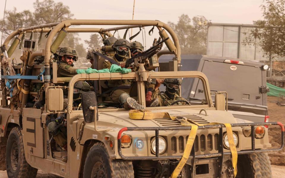 Israeli soldiers reposition in an area in Southern Israel near the Gaza Strip