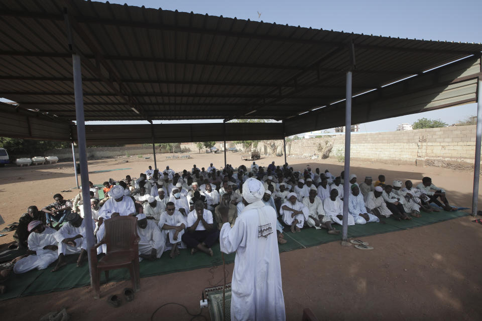 People attend Eid al-Firtr prayer in Khartoum, Sudan, Friday, April 21, 2023. Eid al-Fitr holiday, that marks the end of the holy Islamic month of Ramadan, is marked by faithful as gunshots rang out across the capital of Khartoum and heavy smoke billowed over the skyline. (AP Photo/Marwan Ali)