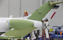 In this July 30, 2019, photo an employee works on an aircraft in the production area at the Honda Aircraft Co. headquarters in Greensboro, N.C. where the HondaJet Elite aircraft is manufactured. Nearly four years after delivering its first jet, Honda is facing decisions as the company better known for cars and lawnmowers considers whether to sink billions more into its decades-in-the-making aircraft division. (AP Photo/Gerry Broome)