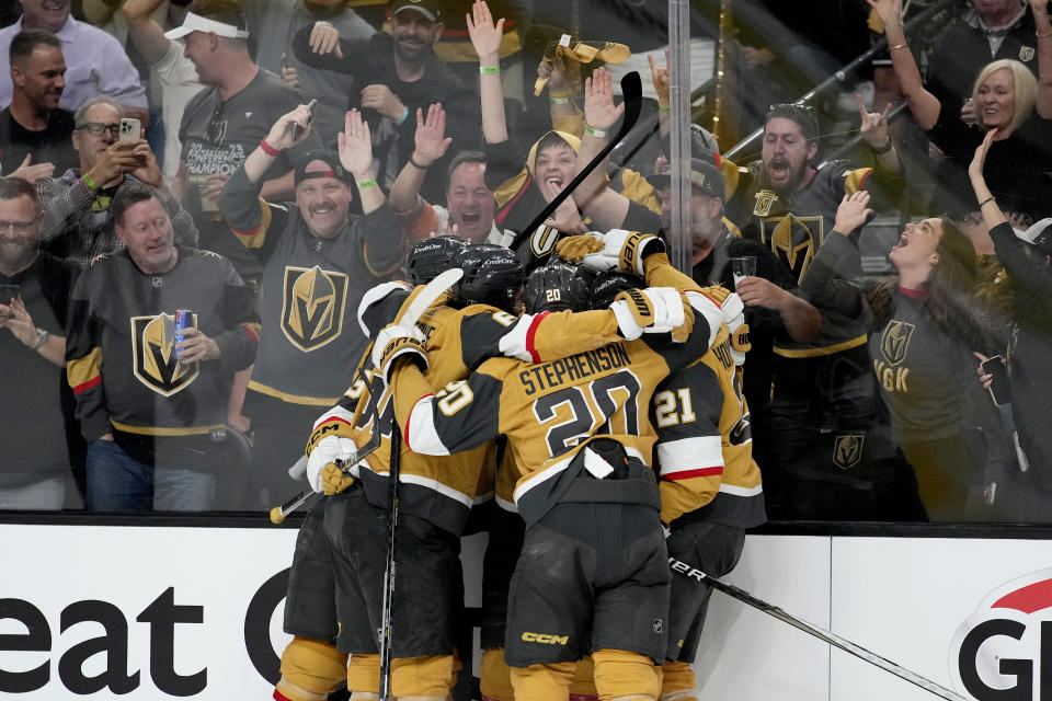 Vegas Golden Knights defenseman Shea Theodore celebrates his goal against the Florida Panthers with teammates during the second period of Game 1 of the NHL hockey Stanley Cup Finals, Saturday, June 3, 2023, in Las Vegas. (AP Photo/John Locher)