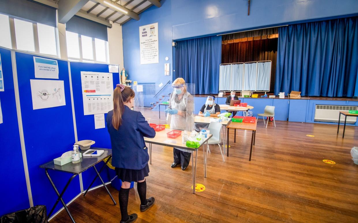 A pupil takes a Covid-19 test in the school hall - Anthony Devlin/Bloomberg 