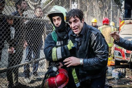 A man reacts at the site of a collapsed high-rise building in Tehran, Iran January 19, 2017. Tasnim News Agency/Handout via REUTERS ATTENTION EDITORS