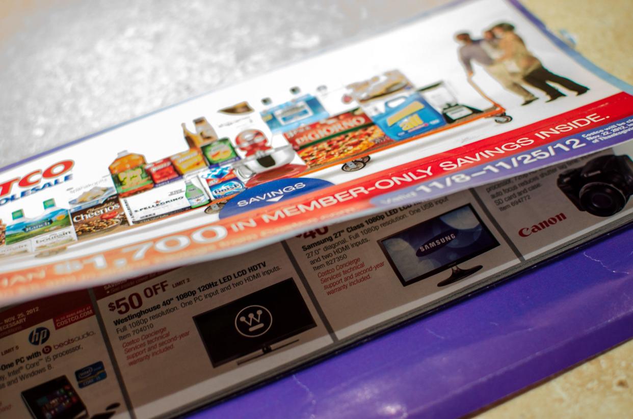 A close up detail shot of a Costco coupon and deals book.