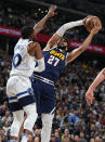 Denver Nuggets guard Jamal Murray, right, goes up for a shot as Minnesota Timberwolves guard Mike Conley defends during the first half of an NBA basketball game Wednesday, April 10, 2024, in Denver. (AP Photo/David Zalubowski)