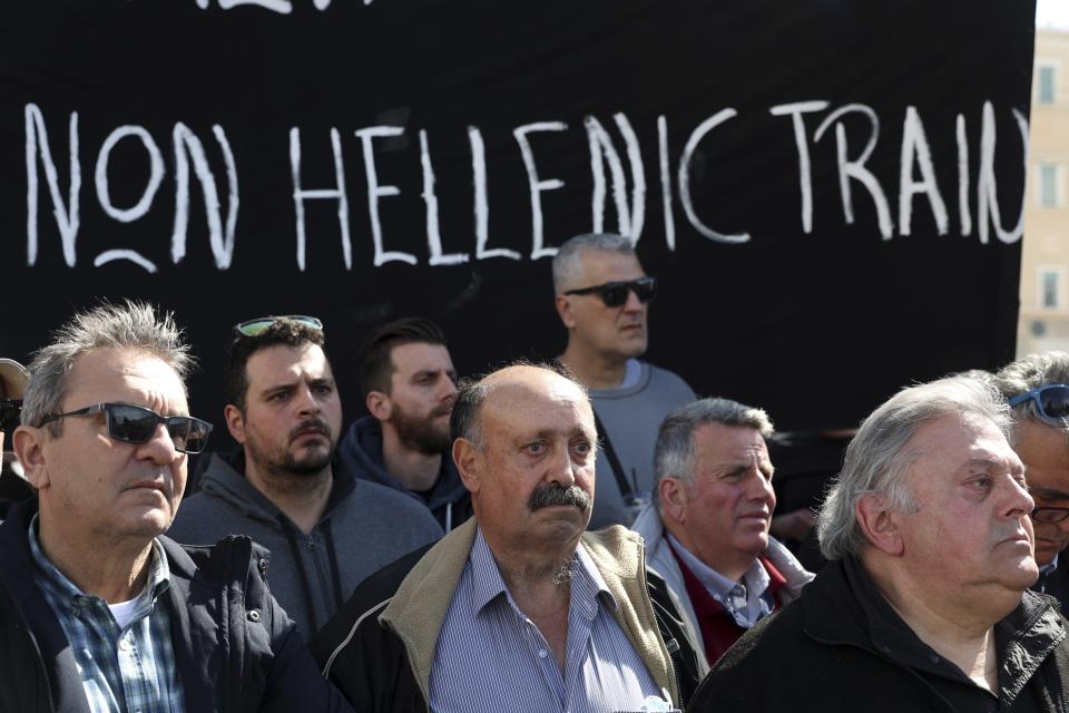 People obverse a minute of silence, during a protest outside the Greek parliament, in Athens, Greece, Sunday, March 5, 2023. Thousands protesters, take part in rallies around the country for fifth day, protesting the conditions that led the deaths of dozens of people late Tuesday, in Greece's worst recorded rail accident. (AP Photo/Yorgos Karahalis)
