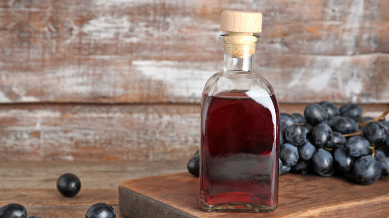 bottle of red wine vinegar with grapes