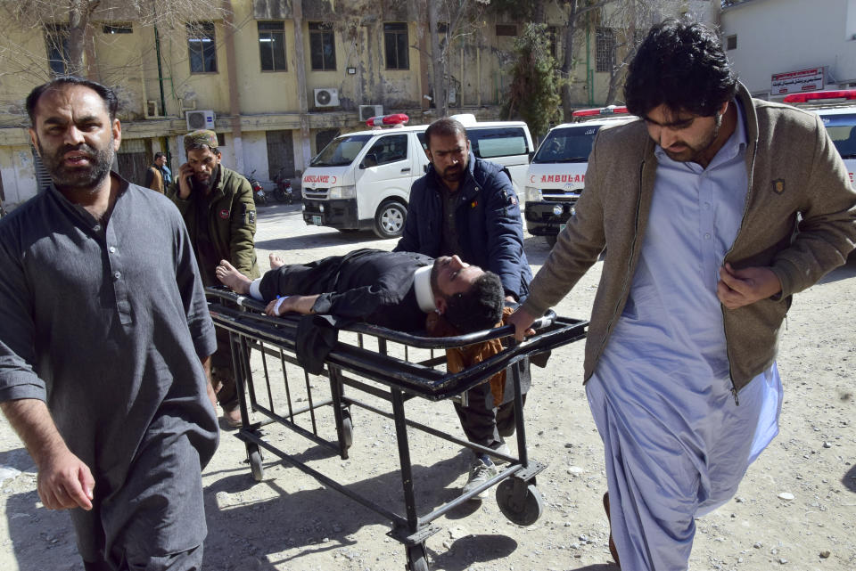 Workers and volunteers transport an injured victim from Pashin district's bomb blast upon arrival at a hospital in Quetta, Pakistan, Wednesday, Feb. 7, 2024. A pair of bombings at the election offices of a political party and an independent candidate in southwest Pakistan killed some people and wounded more, officials said Wednesday, the day before parliamentary elections are to be held. (AP Photo/Arshad Butt)