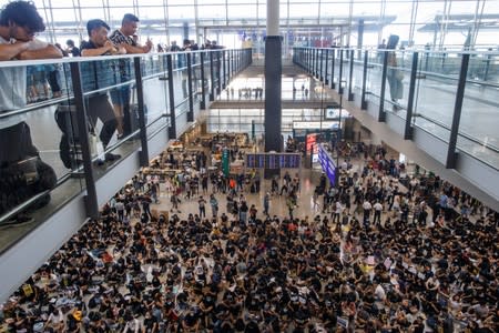 Anti-extradition bill demonstrators attend a protest at the arrival hall of Hong Kong International Airport