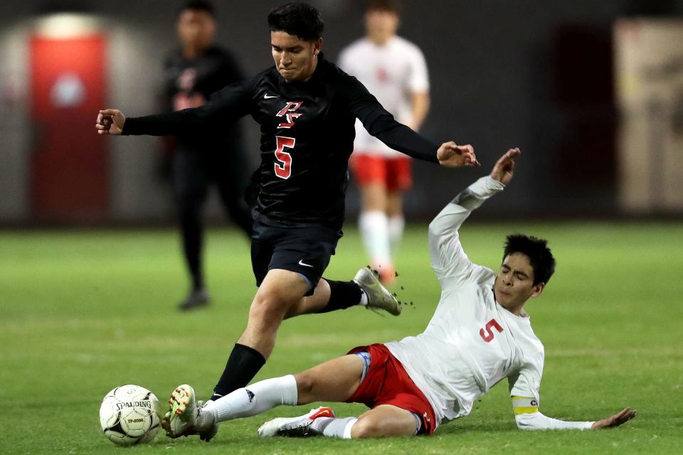 Palm Springs, in black, and Palm Desert soccer players compete in Palm Springs, Calif., on December 2, 2021. 