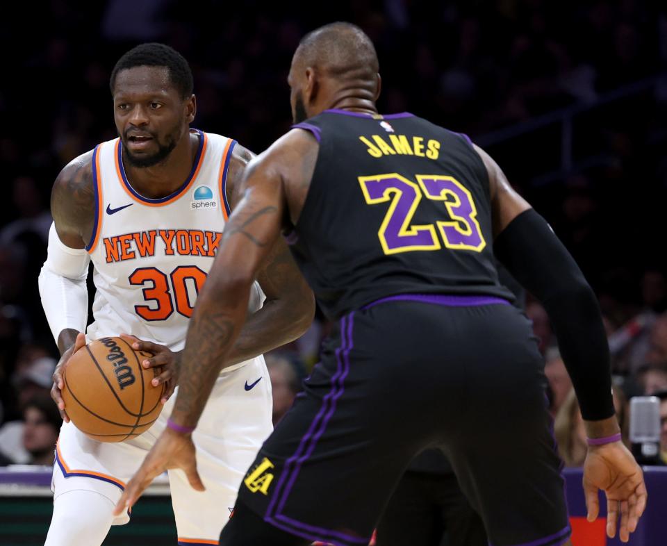 LOS ANGELES, CALIFORNIA - DECEMBER 18: Julius Randle #30 of the New York Knicks controls the ball in front of LeBron James #23 of the Los Angeles Lakers during the first half at Crypto.com Arena on December 18, 2023. (Photo by Harry How/Getty Images)