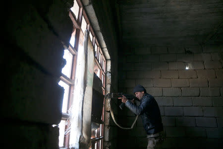 A member of the Iraqi Army fires during clashes with Islamic State militants at the south of Mosul, Iraq December 12, 2016. REUTERS/Ammar Awad