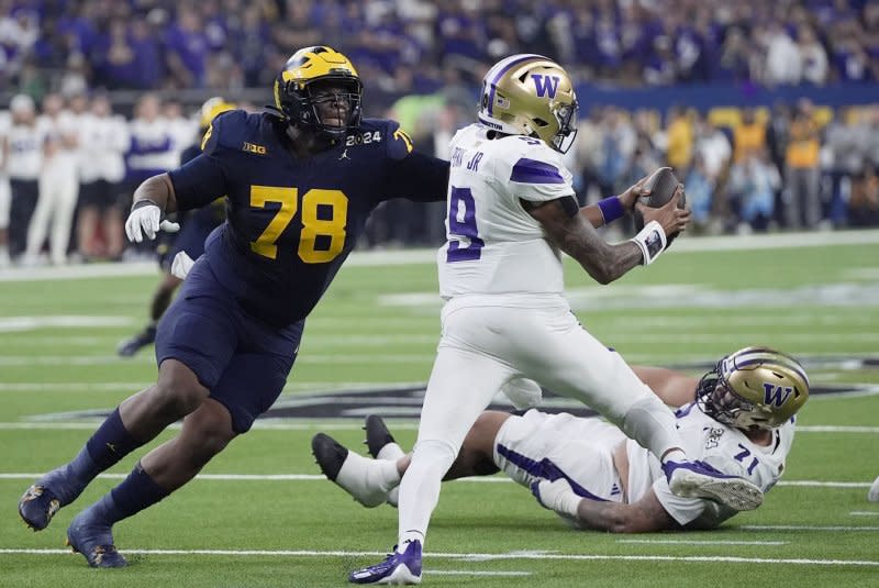 Michigan Wolverines defensive lineman Kenneth Grant (L) sacks Washington Huskies quarterback Michael Penix Jr. in the second quarter of the 2024 College Football Playoff national championship game Monday at NRG Stadium in Houston. Photo by Kevin M. Cox/UPI