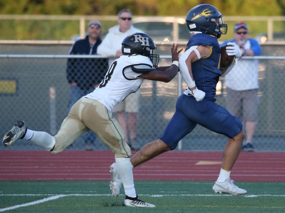 Victor's Drevariis Yeomas sprints away from Rush-Henrietta's Jihad Perry Jr. to score one of his three first half rushing touchdowns.