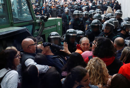 Scuffles break out as Spanish Civil Guard officers force their way through a crowd and into a polling station for the banned independence referendum where Catalan President Carles Puigdemont was supposed to vote in Sant Julia de Ramis, Spain October 1, 2017. REUTERS/Juan Medina