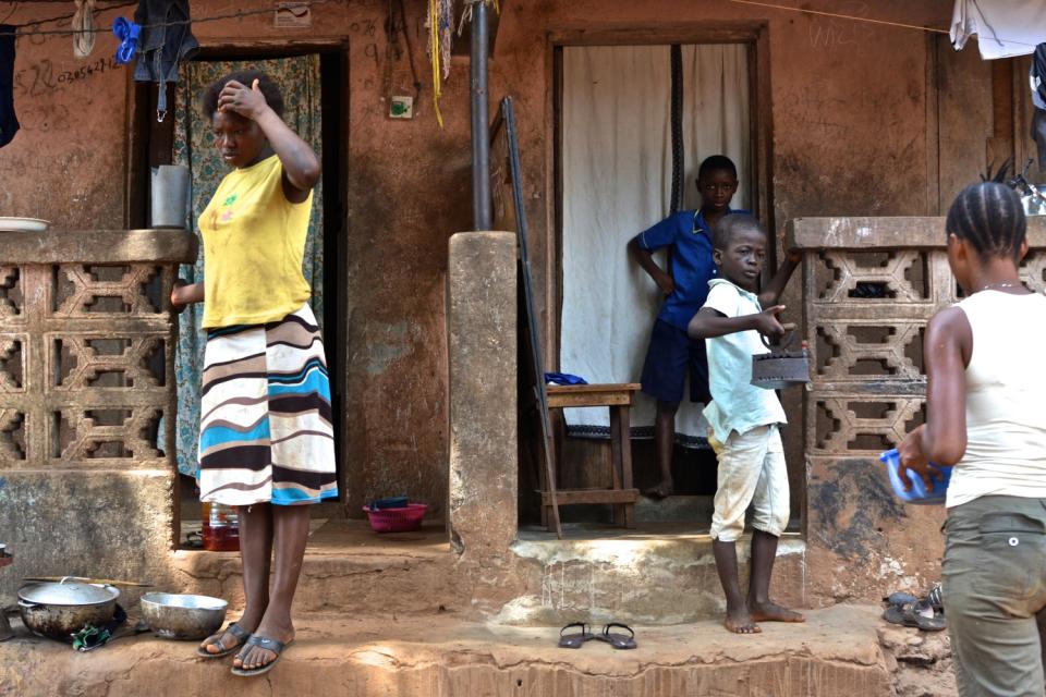 A family of Ebola survivors completes household chores in a village outside Freetown, Sierra Leone, in 2016.