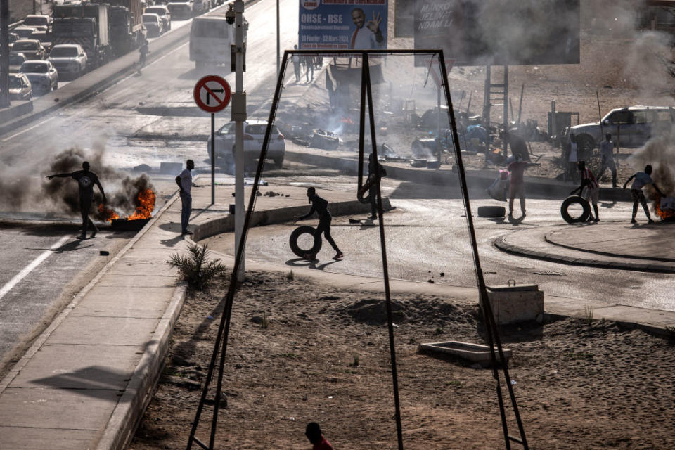 People burn tires as they block a road during demonstrations called by opposition parties to protest the postponement of Senegal’s presidential election, in Dakar on Feb. 4, 2024<span class="copyright">John Wessels—AFP/Getty Images</span>