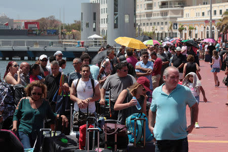 People line up to board a Royal Caribbean cruise ship that will take them to the U.S. mainland, in San Juan, Puerto Rico September 28, 2017. REUTERS/Alvin Baez