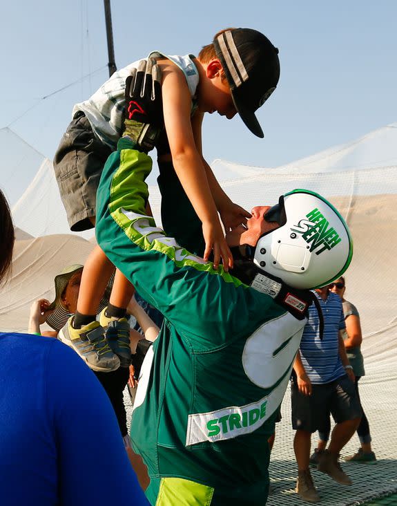 Skydiver Luke Aikins celebrates with son Logan after jumping 25,000 feet from an airplane without a parachute or wing suit as part of 'Stride Gum Presets Heaven Sent' on July 30, 2016 in Simi Valley, California.