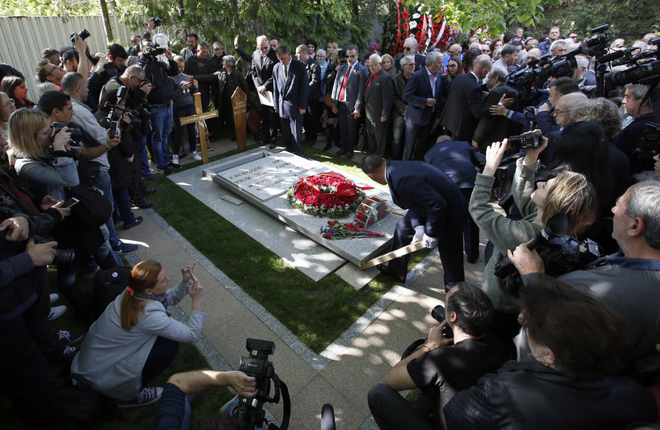 Workers place the stone onto the tomb of Mirjana Markovic, the widow of former strongman Slobodan Milosevic during her funeral at the yard of his estate in his home town of Pozarevac, Serbia, Saturday, April 20, 2019. Markovic died last week in Russia where she had been granted asylum. The ex-Serbian first lady had fled there in 2003 after Milosevic was ousted from power in a popular revolt and handed over to the tribunal in The Hague, Netherlands. (AP Photo/Darko Vojinovic)