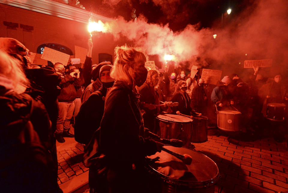 People protest against imposing further restrictions on abortion law in front of the Presidential palace in Warsaw, Poland, Sunday, Oct. 25, 2020. (AP Photo/Czarek Sokolowski)