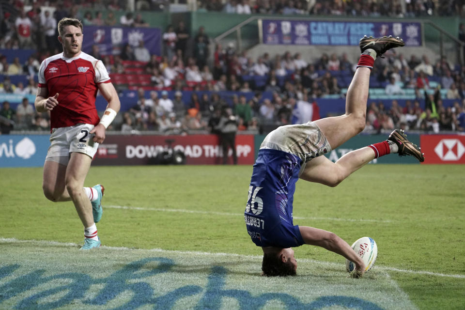 France's Paul Leraitre flips to celebrate after scoring a try during the second day of the Hong Kong Sevens rugby tournament in Hong Kong, Saturday, April 1, 2023. (AP Photo/Anthony Kwan)