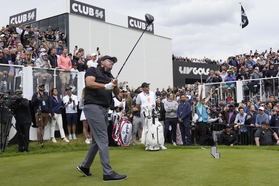 Phil Mickelson of the United States plays from the first tee during the first round of the inaugural LIV Golf Invitational at the Centurion Club in St. Albans, England, Thursday, June 9, 2022. (AP Photo/Alastair Grant)