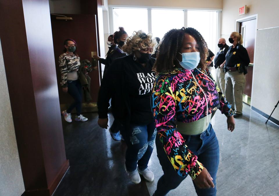 Tamika Palmer, right, walks out of the courtroom at the Judicial Center in Louisville, Ky. on Mar. 3, 2022 after former LMPD officer Brett Hankison was found not guilty for wanton endangerment in the March 2020 shooting that left her daughter, Breonna Taylor, dead. 