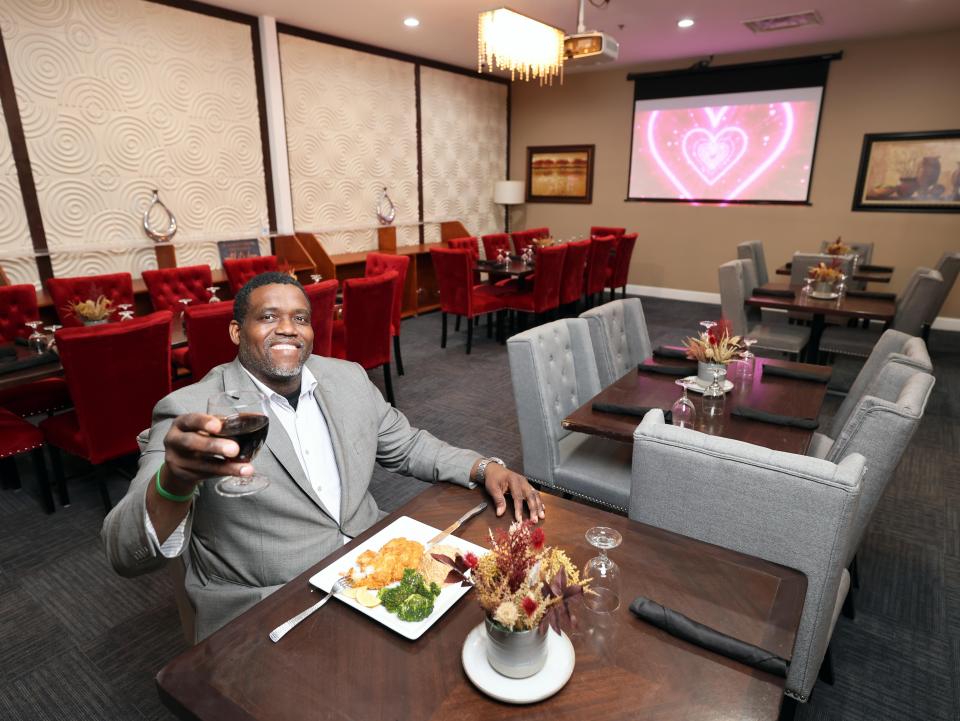 Sunrise Steakhouse owner Ruben Pierre shows off a dish at the new restaurant on Centre Street in Brockton on Thursday, Feb. 8, 2024. The restaurant offers a "fusion of Haitian flavors and cuisine with a mixture of the traditional American fine dining steakhouse," he said.