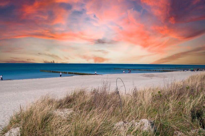 sunset over the beach on the Baltic Sea in Warnemuende, Germany