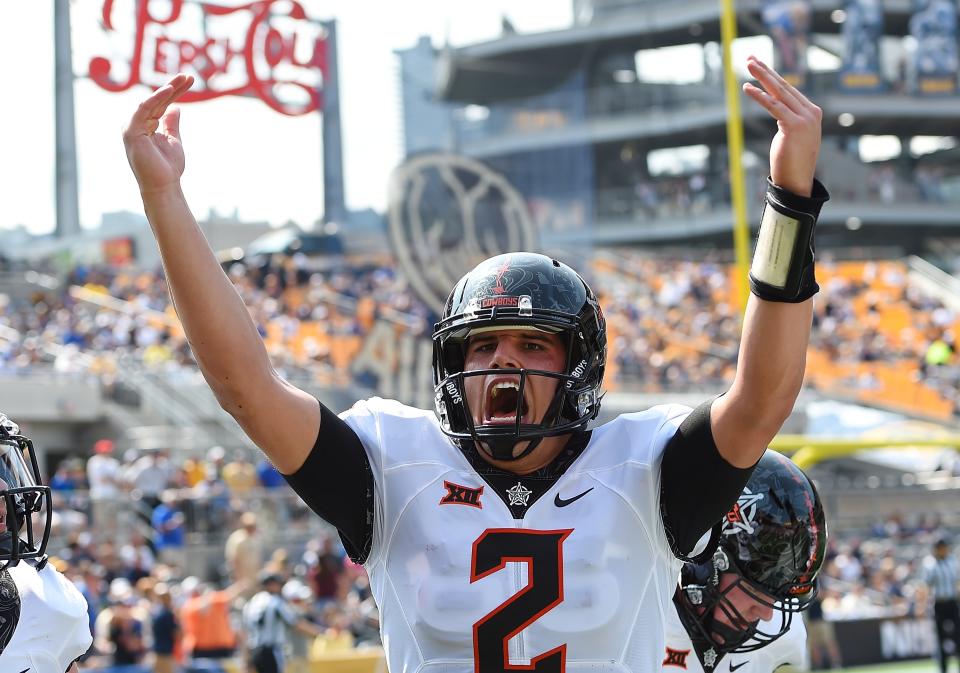 Oklahoma State QB Mason Rudolph celebrates after a touchdown during the first quarter against the Pittsburgh Panthers. (Photo by Joe Sargent/Getty Images)