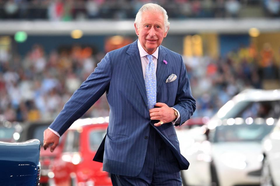 Britain's Prince Charles, Prince of Wales, steps out of an Aston Martin sports car after driving himself and Britain's Camilla, Duchess of Cornwall into the opening ceremony for the Commonwealth Games, at the Alexander Stadium in Birmingham, central England, on July 28, 2022. 