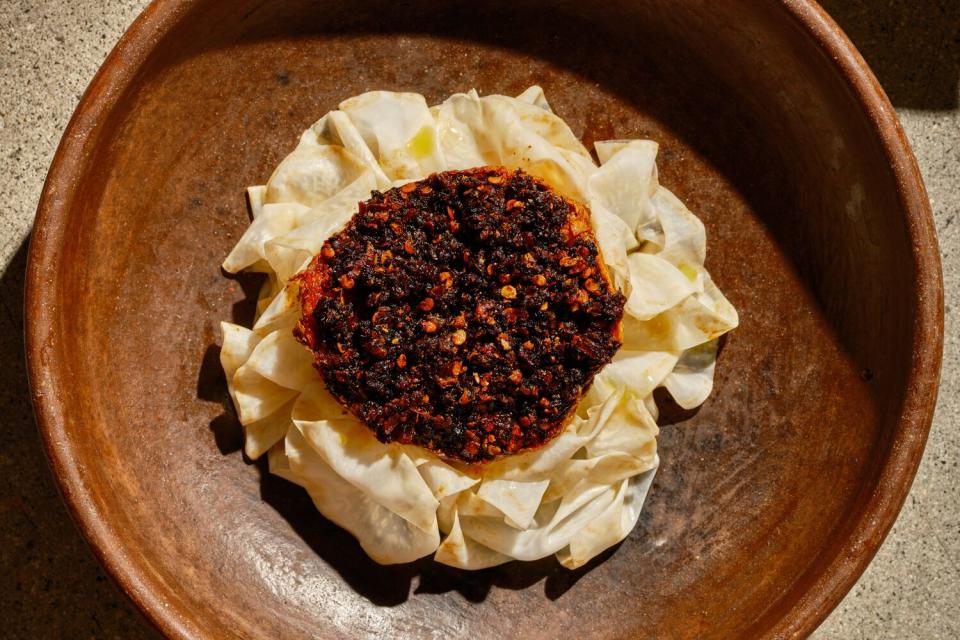 A mound of celery root piled with mole.