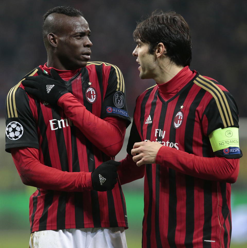AC Milan's forward Mario Balotelli, left, is encouraged by team's captain Ricardo Kaka after he injured himself during a round of 16th Champions League soccer match between AC Milan and Atletico Madrid at the San Siro stadium in Milan, Italy, Wednesday, Feb. 19, 2014. (AP Photo/Emilio Andreoli)