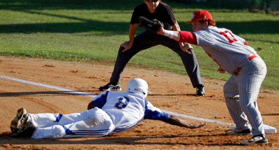 Loris High School’s Desmond Dozier dives back to first base and was called safe as Wade Hampton High School’s Buster Murdaugh catches the ball on Friday, May 16, 2014. Loris ost the first game of the night. Photo by Janet Blackmon Morgan / jblackmon@thesunnews.com