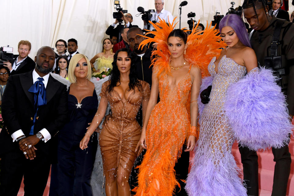 The Kardashian wearing various brightly colored dresses