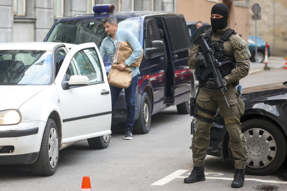 A member of the special police unit of Canton Sarajevo stands guard during the arrests of people in an operation codenamed "Black Tie" in Sarajevo, Bosnia, Monday, April 22, 2024.In a large-scale raid conducted in Bosnia and Herzegovina, law enforcement officers swarmed homes and offices of 23 persons suspected to be part of the 'inner circle' of a drug kingpin. (AP Photo/Armin Durgut)