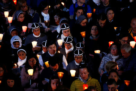 People attend the Via Crucis (Way of the Cross) procession led by Pope Francis during Good Friday celebrations at Rome's Colosseum, Rome, Italy April 19, 2019. REUTERS/Yara Nardi