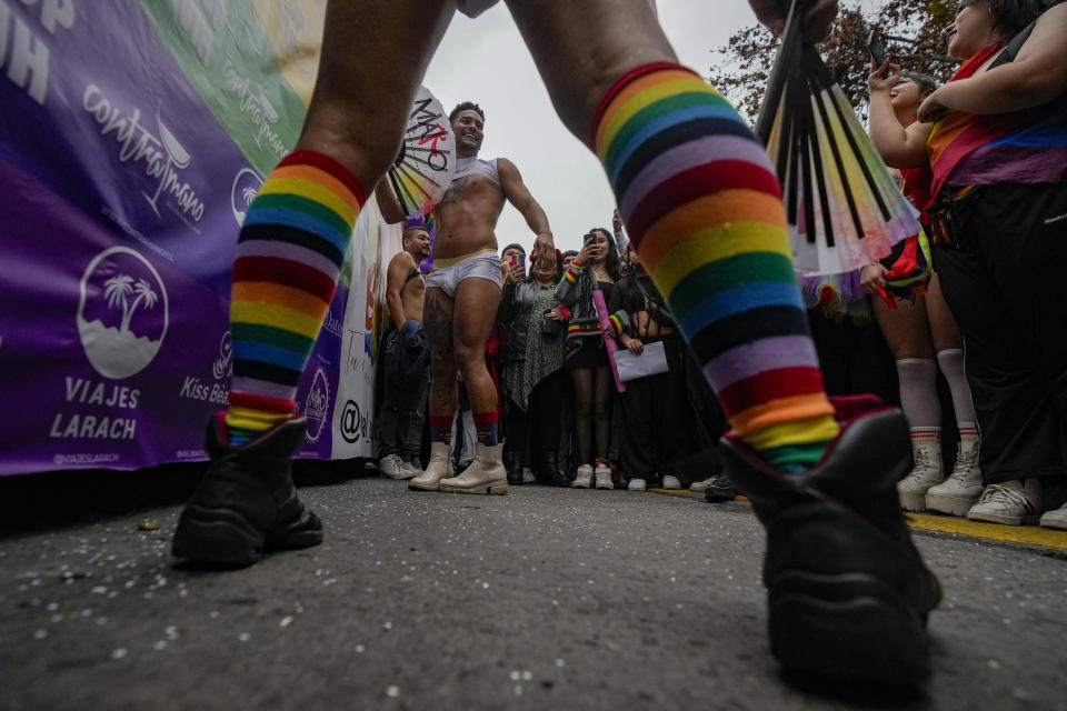 Men dance during the annual Pride march in Santiago, Chile, Sunday, June 25, 2023. (AP Photo/Esteban Felix)