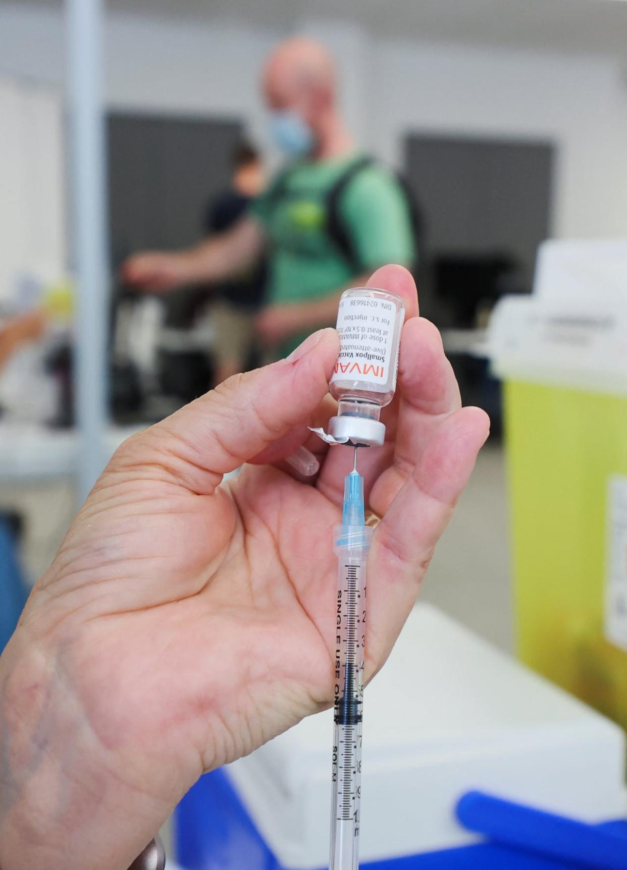 A health-care worker prepares a syringe filled with the mpox vaccine in Montreal. Toronto Public Health is advising eligible Torontonians to get vaccinated against mpox amidst rising cases in the city this year.  (Christinne Muschi/Reuters - image credit)