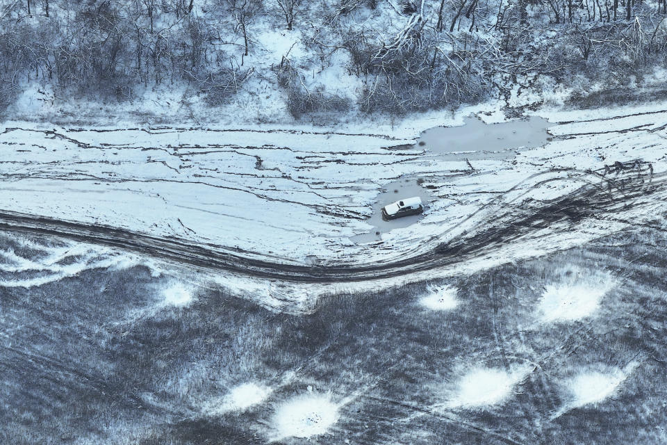 FILE - An aerial view of a car abandoned on the front line is seen near Bakhmut, Donetsk region, Ukraine, Wednesday, Nov. 22, 2023. After blunting Ukraine's counteroffensive from the summer, Russia is building up its resources for a new stage of the war over the winter, which could involve trying to extend its gains in the east and deal significant blows to the country's vital infrastructure. Russia has ramped up its pressure on Ukrainian forces on several parts of the more than 1,000-kilometer (620-mile) front line. (AP Photo/Alex Babenko, File)